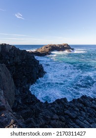 Rough Ocean Water Around The Rocky Formation.