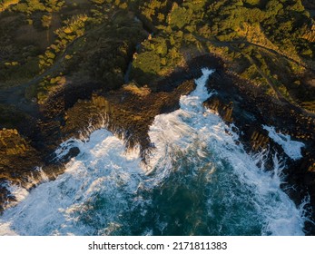 Rough Ocean Water Around The Rocky Coastline.