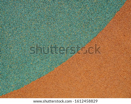 Rough orange and emerald surface close-up, background