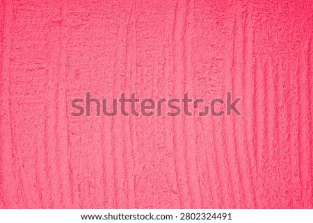 Rough pink plaster texture with vertical striations.