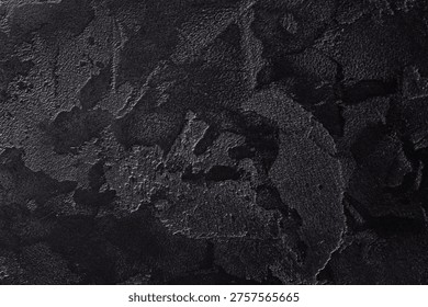 Rough plaster surface in deep black tones ideal for modern food styling and minimalistic tabletop compositions