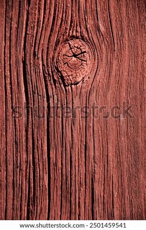 A rough red painted old plank, needs new paint. wood, red-painted, old redpainted wooden plank. background. Grain rings, knots and cracks.   
