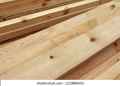 Rough sawn Scots pine boards stack on the construction site