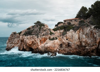 Rough Sea At A Cliffed Coast And A Lonely House