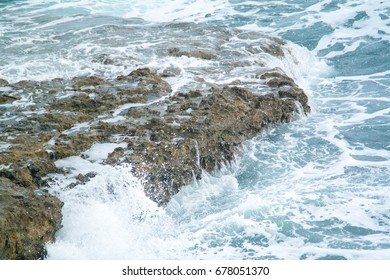 Rough sea crashing against rocks. Waves and seascape background. 