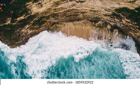 Rough sea rolling on rocky bluff with turquoise water in summer day near mountain coast in resort on stormy weather - Powered by Shutterstock