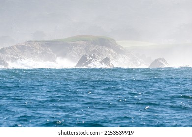 Rough seas off the californian coast breaking their waves against the steep cliffs.
