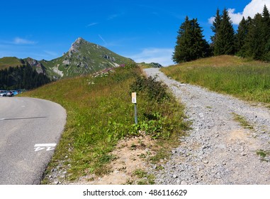 Rough and smooth mountain roads intersection - sunny day 