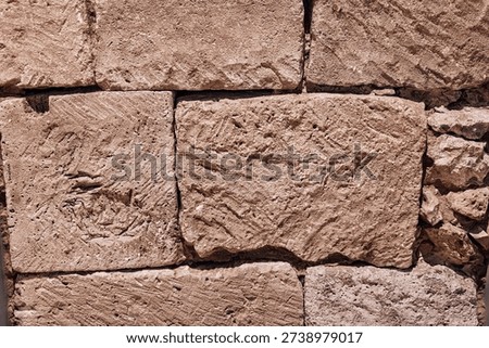 Rough stone wall surface showing ancient masonry texture for architectural backgrounds, strong construction, and solid foundations