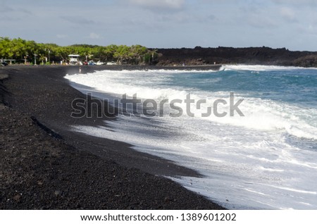 Rough surf  at edge of black sands of Pohoiki  beach, Isaac Hale Beach Park, Big Island, hawaii