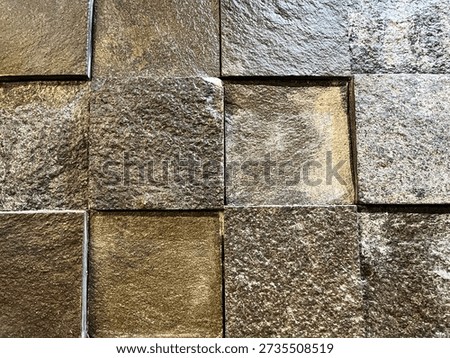 Rough surface texture of a checkered stone tile wall pattern.  Evokes natural and Zen feel. Usable for backgrounds, textures, materials, housing development, and interior design projects.