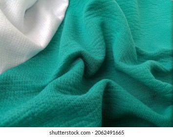 rough surface texture of white striped green fabric.  thick soft cloth.  sports uniforms