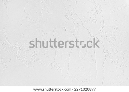 Rough surface of a white painted plastered wall of a living room as a background and copy space