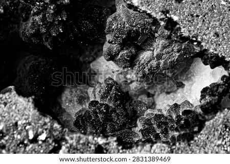 Rough texture with crystalline formations inside a hollow.
