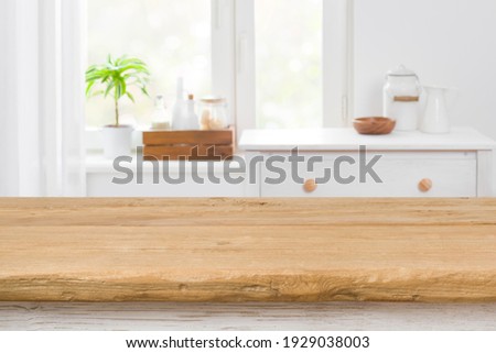 Rough texture table for product display before blurred kitchen window