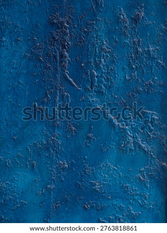 rough textured plaster wall background with blue paint
