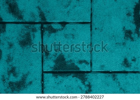 Rough textured surfaces with darker, irregular markings across them.