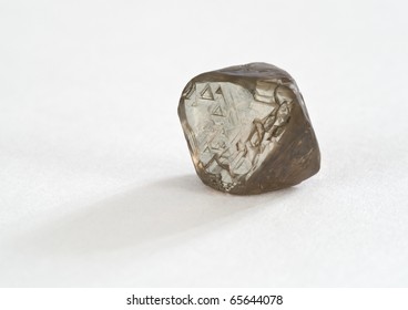 A Rough, Uncut, Brown Diamond On White.