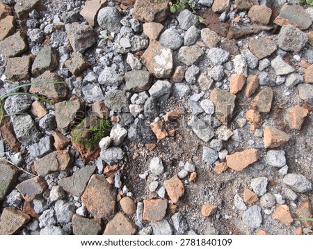 Rough and uneven ground surfaces, often referred to as construction rubble or hardcore.