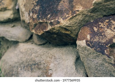 Rough Wall Of Untooled Stones Side View With Natural Shaggy Texture. Sandstone Garden And Nature Background.