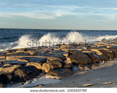 Rough waves splash on the jetty.