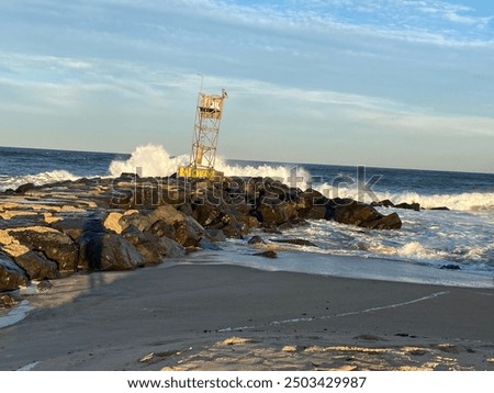 Rough waves splash on the jetty.