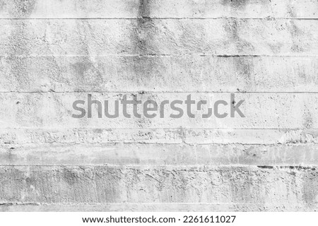 Rough white concrete wall with imprint relief of wooden formwork, background photo texture 