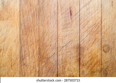 Rough wooden used cutting board background with vertical lines and cutting traces