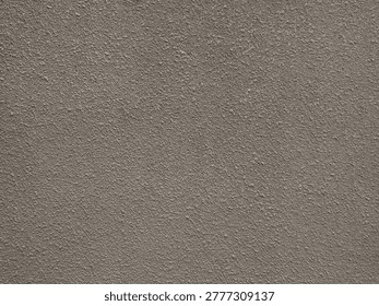Roughcast plaster wall featuring rugged, pebbled texture