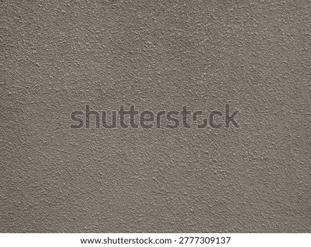 Roughcast plaster wall featuring rugged, pebbled texture