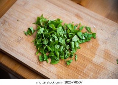 Roughly Chopped Basil On A Wooden Board