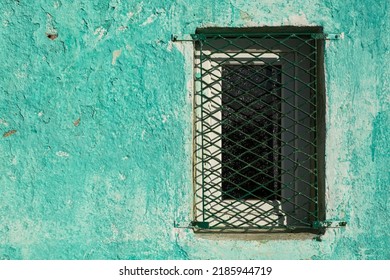 Roughly Green Painted Wall And Window With Metal Railing Protection. Minimalism, Tranquility, Nature, Simplicity, Naturalness, Green Concept.