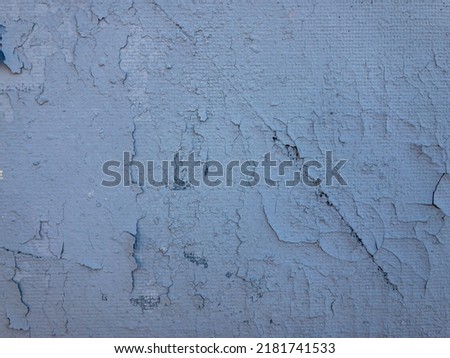 Roughly painted blue wall. Evidence of blue paint. Beautiful Abstract Grunge Blue Stucco Wall Background. Art Rough Stylized Texture surface With Space For Text