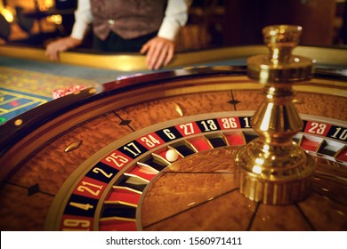 Roulette Wheel And Croupier Hand No Table In Casino.