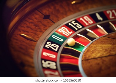 Roulette wheel with a white ball on green at zero number in a casino