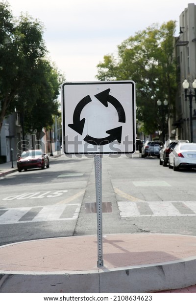 Round About Sign. A\
traffic Round About sign in the middle of a street. Traffic Sign.\
USA Traffic Sign. 