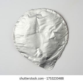 round aluminum thin lid for plastic yogurt jars, sour cream on a white background, top view - Shutterstock ID 1753233488