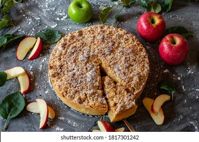 round Apple crumble cake on dark background