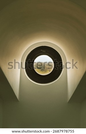 Round attic window in daylight