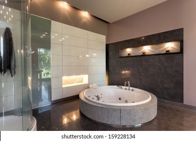 Round Bath In A Luxury Tiled Bathroom Interior