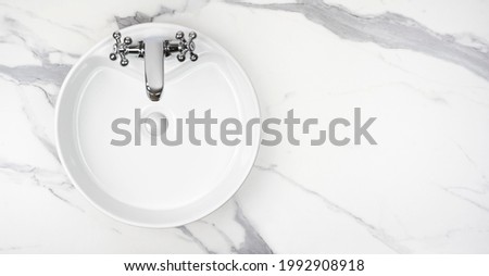 Round bathroom washing sink on marble stone surface, top view