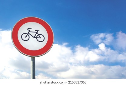 Round bicycle sign transit prohibited for bicycles on a blue sky background. Bicyle road sign, prohibition red sign.