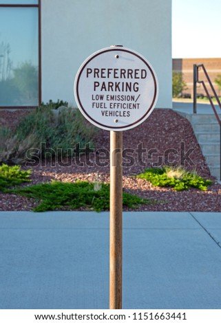 A round black and white preferred parking sign for low emission/ fuel efficiency vehicles.