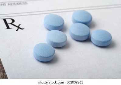Round Blue Pills Spread Out on a Blank Prescription Form. Medical Theme