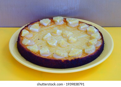 A Round Boiled Meyer Lemon, Almond And Olive Oil Cake With Sliced Lemons On Top