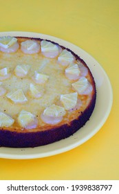 A Round Boiled Meyer Lemon, Almond And Olive Oil Cake With Sliced Lemons On Top