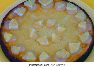 A Round Boiled Meyer Lemon, Almond And Olive Oil Cake With Sliced Lemons On Top