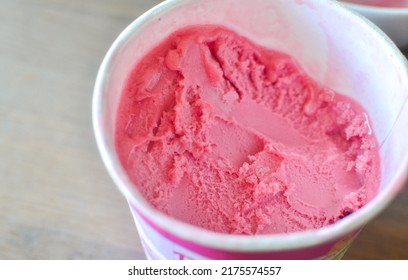 Round Box Of Rasberry Sorbet Ice Cream Straight Out From The Freezer.