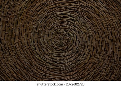 A Round Brown Rug, Hand-woven From Pine Needles, Photographed From Above With A Center In The Middle