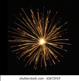 Round burst of orange fireworks with feathery motion blur and white-hot core of explosion Arkivfotografi